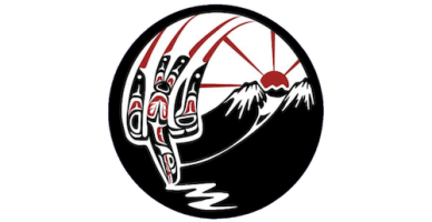 Logo with a stylized Indigenous upside-down bird in black, white, and red, flying in front of a red rising sun over snowy mountain peaks, all enclosed in a black circle.